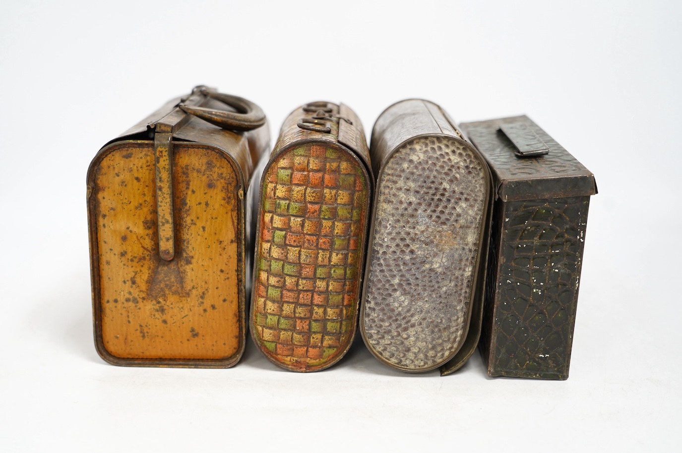 Four biscuit tins: an early 20th century Huntley & Palmers novelty biscuit tin, modelled as a Gladstone bag, 20cm wide, 16cm high, two other Huntley & Palmers tins and a Peek Frean novelty biscuit tin. Condition - fair